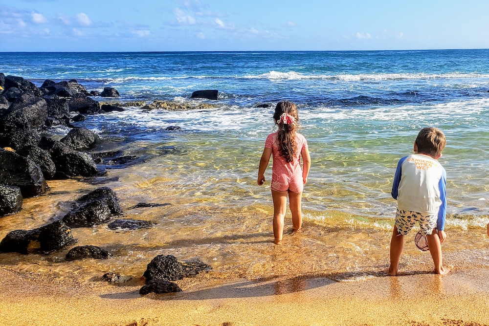 kids on beach in Kauai